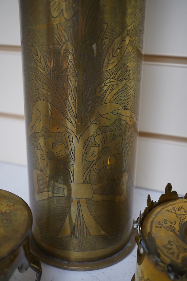 Trench Art, an engraved brass shell case, a similar box engraved ‘Ypres’ and a trivet, largest 50cm high. Condition - fair/good